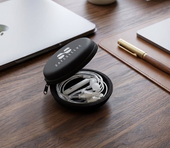 Open SafeSleeve zip case holding white Air-Tube headphones on a wooden desk