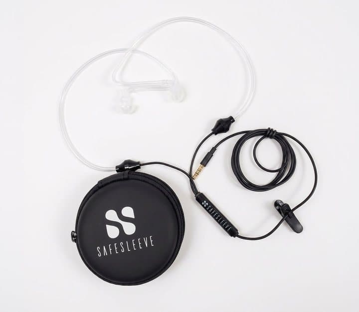 Air-Tube headphones coiled beside their round black SafeSleeve zip case on a white surface