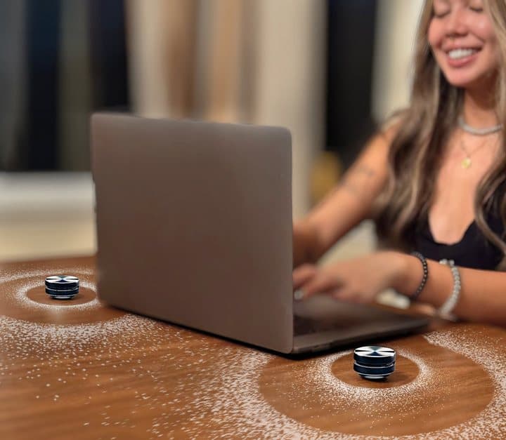 Two Anything Speakers on a wooden desk on either side of a laptop as a stereo pair