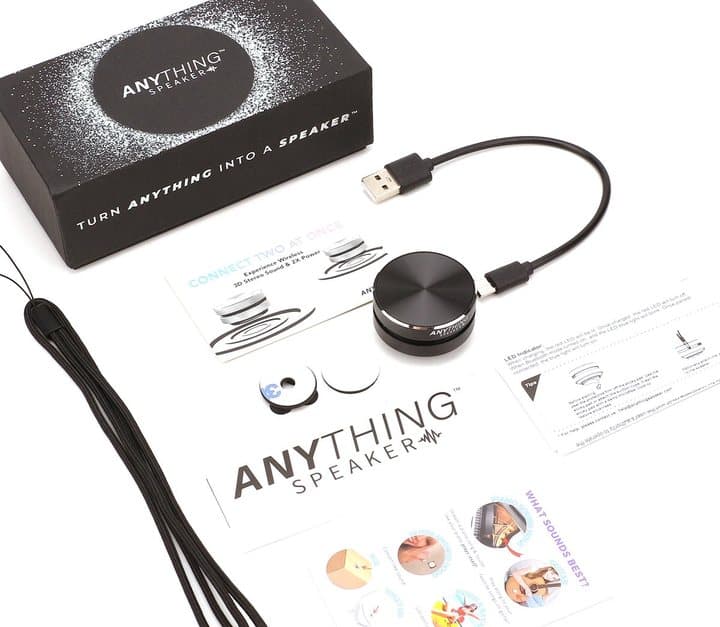 Anything Speaker box contents laid out: speaker, USB charging cable, lanyard and instruction cards
