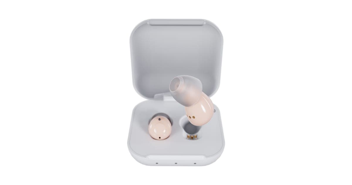 Pair of small beige Audien in-ear hearing aids in a white charging case