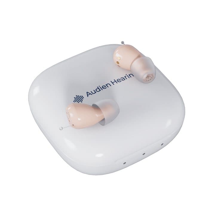 Audien Atom One hearing aids showing two small dials marked f and V on each faceplate