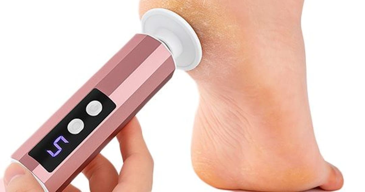 Rose-gold CallusClear Pro foot file with a speed display reading 5 buffing the heel of a bare foot
