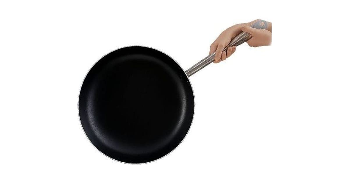 Black Chiefs Pan non-stick frying pan with a long stainless steel handle held by one hand