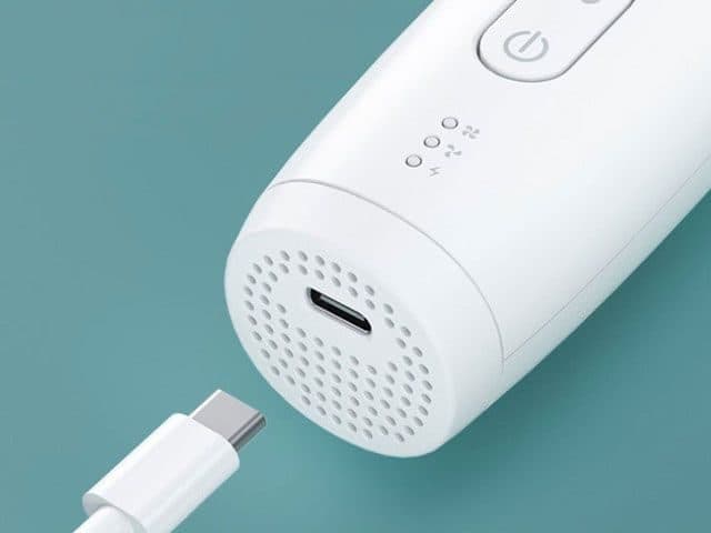 Base of the white CleanTrim Pro with a USB-C port surrounded by vent holes, a USB-C cable and three indicator lights