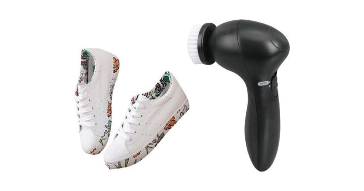 Black CleanX handheld shoe brush with a white rotating brush head, beside a pair of white floral sneakers