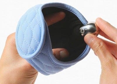 Hands inserting the steel ice pod into the inside of the light blue CoolCura neckband