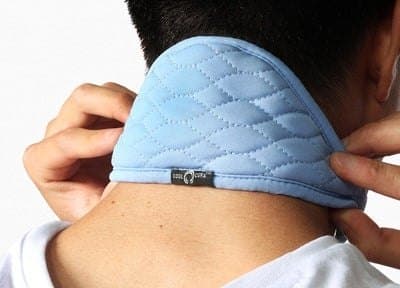 Person adjusting the light blue CoolCura neckband at the back of their neck