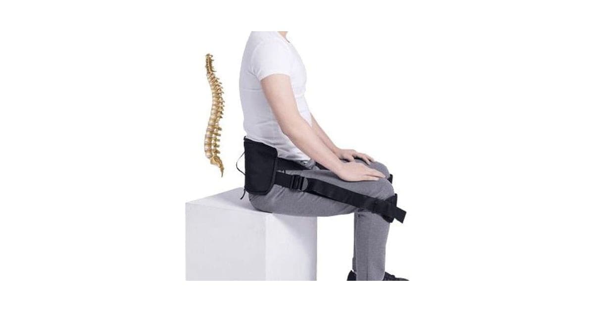 Man sitting on a white block wearing the black CorrectBack pad across his lower back with straps looped over his knees, beside a spine illustration