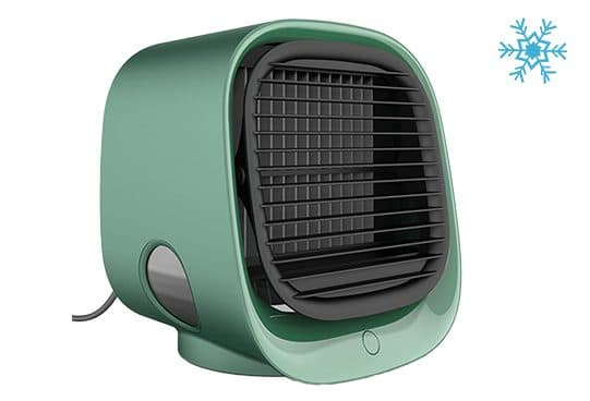 Green FreshBreeze cube cooler from the front corner, showing the grille, horizontal louvres, a round water level window and a power cable