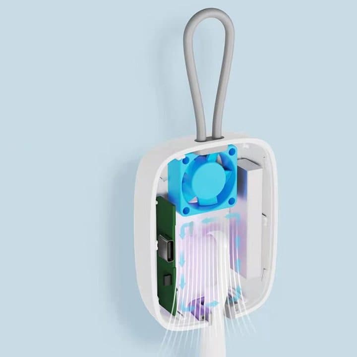 Cutaway of the GermsPurge Pro case showing a small blue fan, a circuit board with a USB-C port and air arrows flowing around a toothbrush head