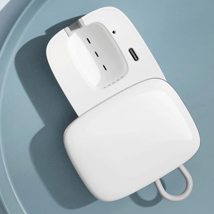 GermsPurge Pro case opened flat on a blue plate, showing the brush slot with LED holes, an indicator light and a USB-C charging port