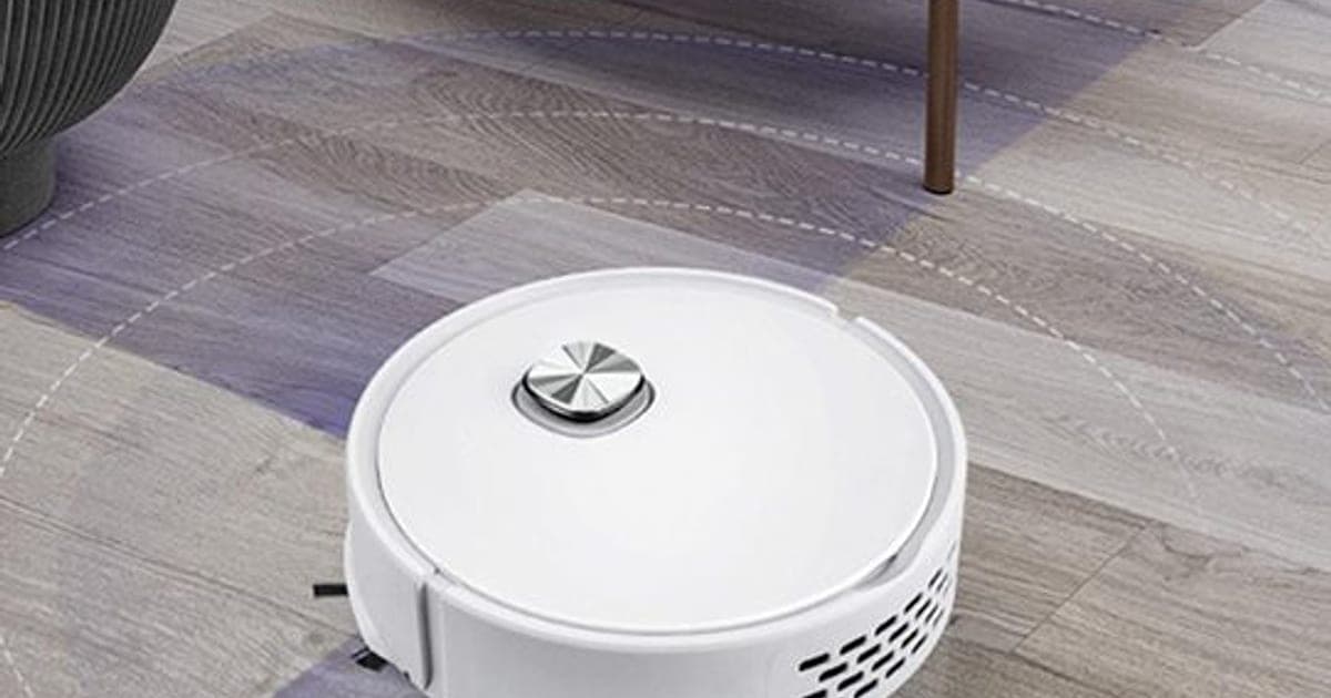 White round GoClean Robot vacuum with a silver top button on a grey wood-effect floor, with faint circles showing its sensor range