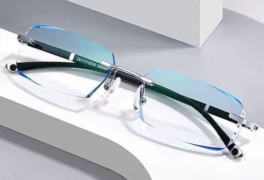GuardBlue Vision rimless glasses with blue-edged lenses, a silver bridge and nose pads, and arms marked 55 17-142