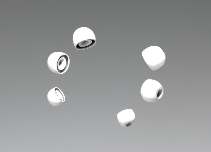 Four white Hears ear tips in different sizes floating on a grey background