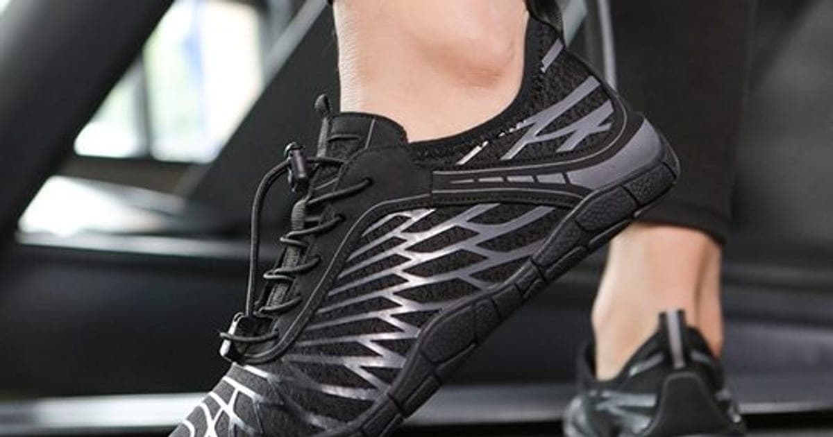 Black and silver HikeGrip Pro mesh barefoot shoes with toggle laces and a chunky black sole, worn on a treadmill