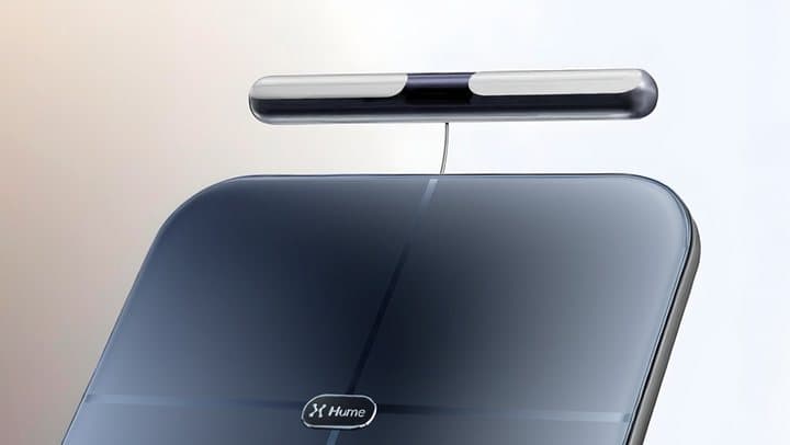 Close-up of the Hume Body Pod's metal handle bar raised above the dark glass platform