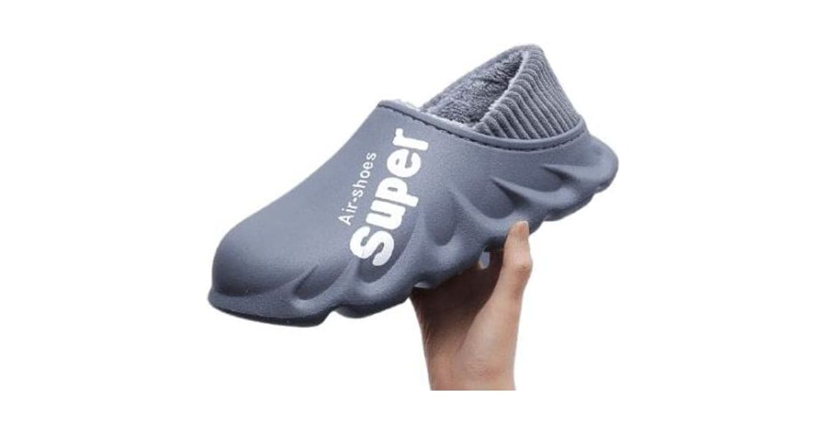 Grey HyperShoes clog with a chunky wavy sole, fleece-lined ribbed collar and Super Air-shoes printed on the side, held in a hand