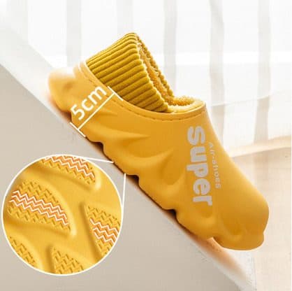 Yellow HyperShoes on a step with a 5 cm sole height marker and a close-up of the zigzag tread pattern