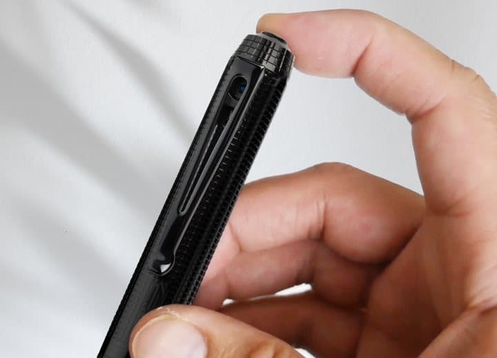 Finger pressing the top button of the iSpyPen Pro X to start recording