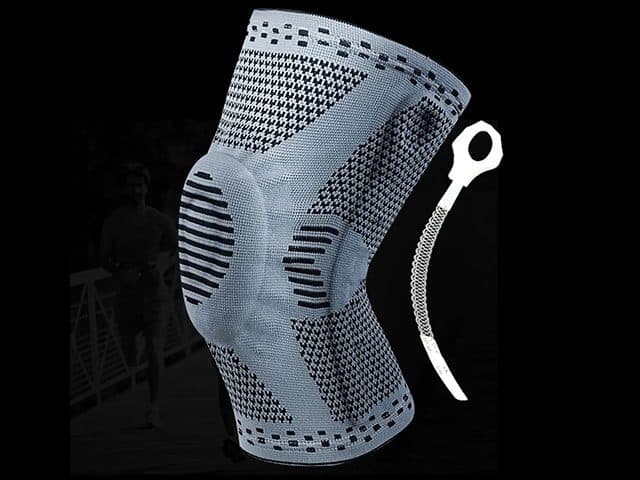 KneeBoost Pro sleeve beside a white coiled side spring stay with a ring at the top, with a runner in the background