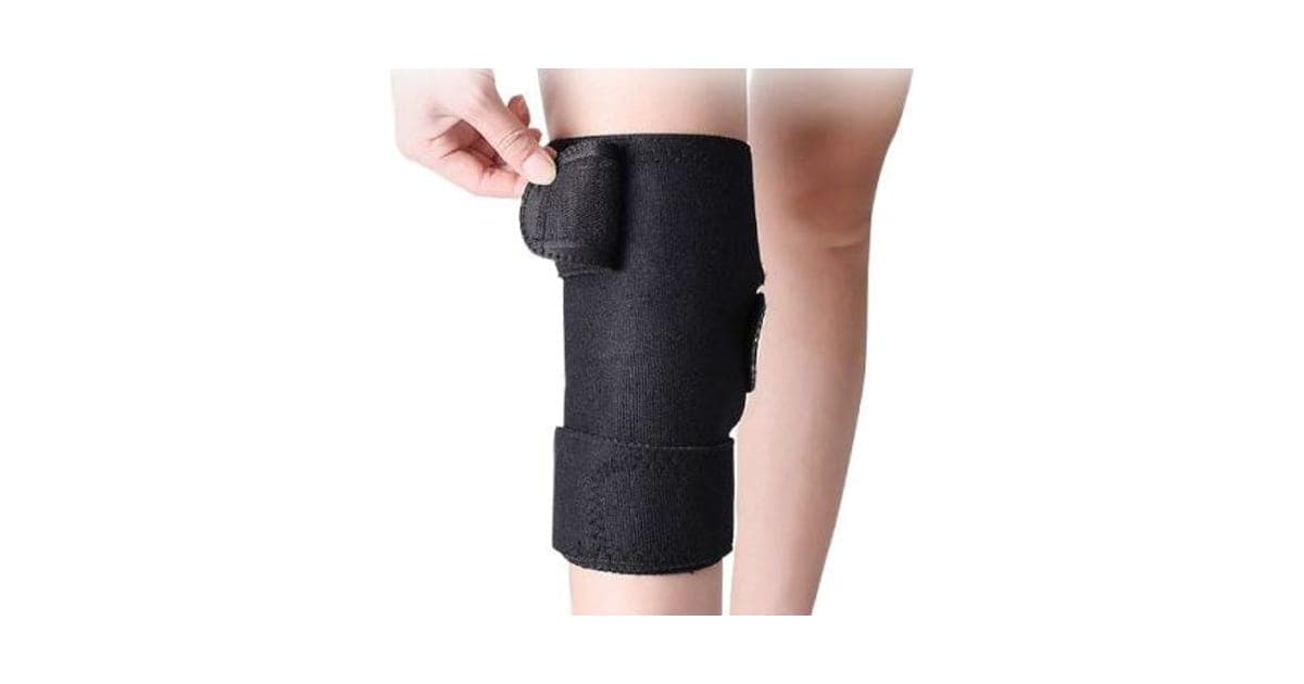 Black KneeWrap Pro knee wrap with hook-and-loop straps above and below the knee, fastened on a bare leg