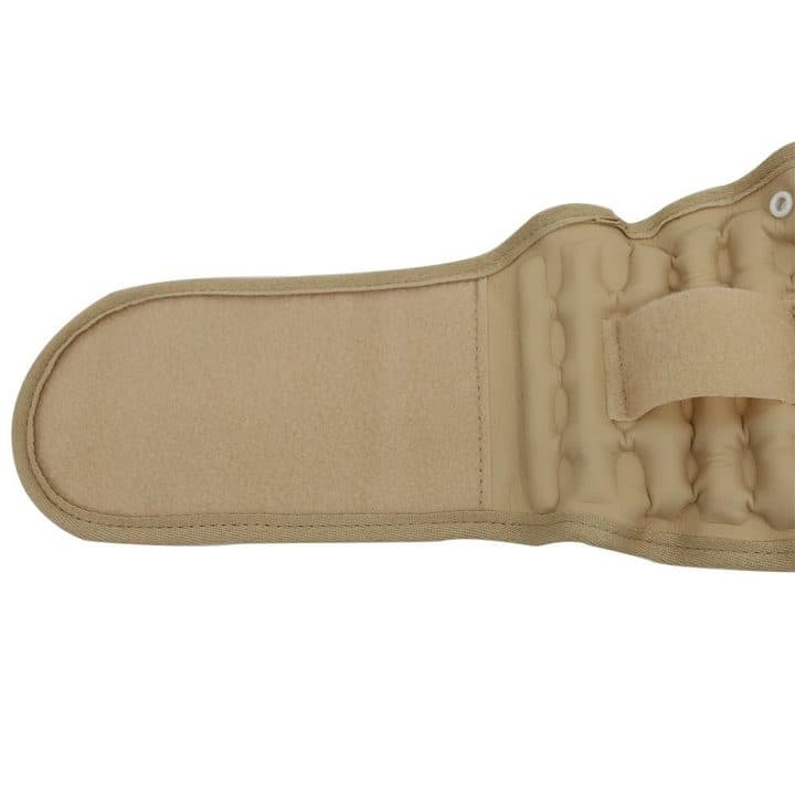 Close-up of the beige belt's hook-and-loop end panel and quilted air columns