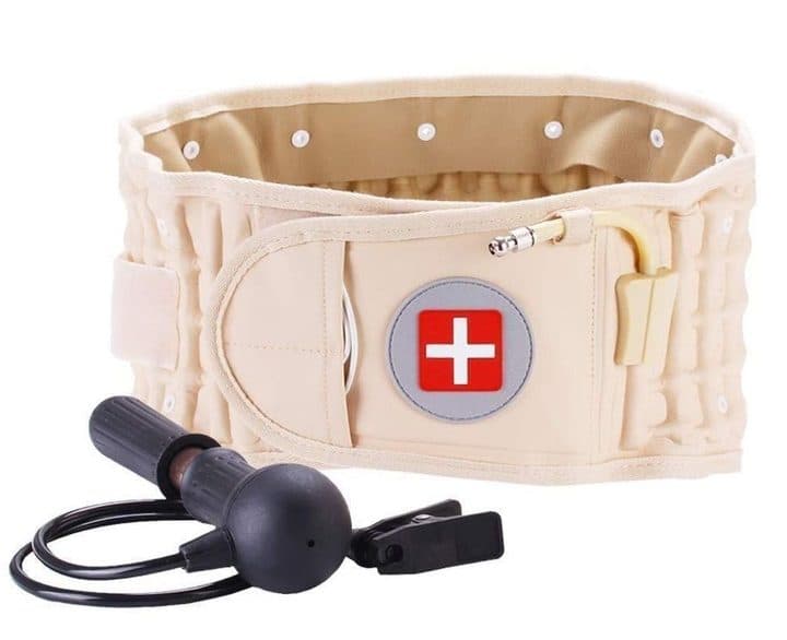 Beige inflatable belt with a red cross badge and brass valve, next to a black rubber hand pump with tubing