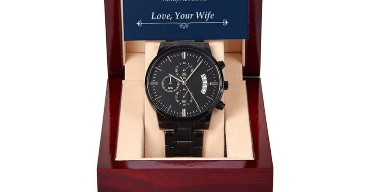 All-black Luxury Watch chronograph with three sub-dials on a black link bracelet, in an open red-brown mahogany-style box under a navy To My Husband card