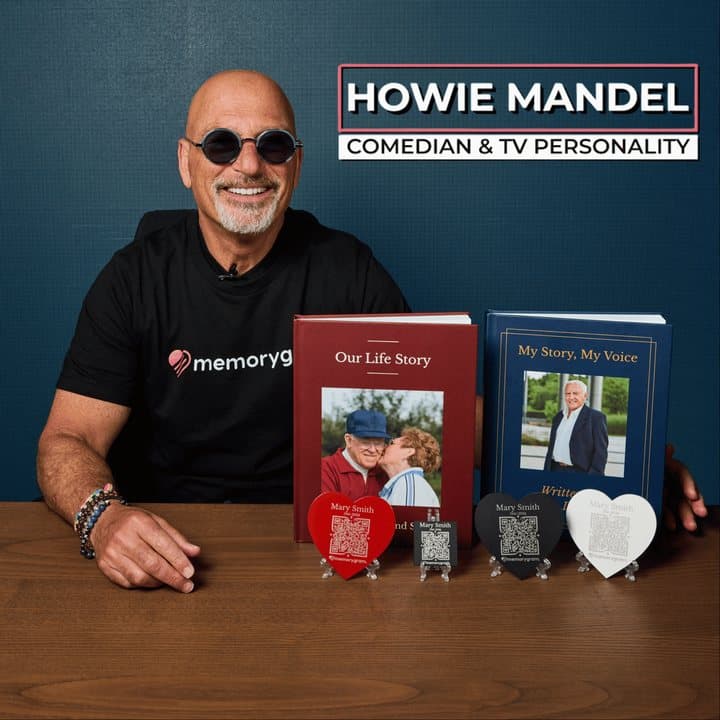 Comedian Howie Mandel seated at a table with Memorygram books in front of him