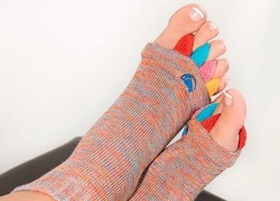 Side view of a foot in a My Happy Feet Sock with toes spread by the spacers