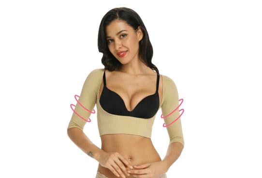 Woman in a beige MyCorrector Pro shrug with three-quarter sleeves and an under-bust band, with pink curved arrows on the upper arms