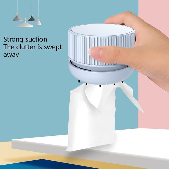 Hand holding a round blue desk vacuum lifting a tissue, with the words strong suction, shown as the USB power add-on image