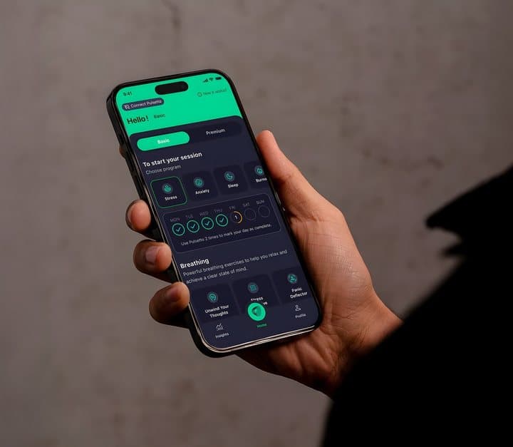 Hand holding a phone showing the Pulsetto app home screen with session options