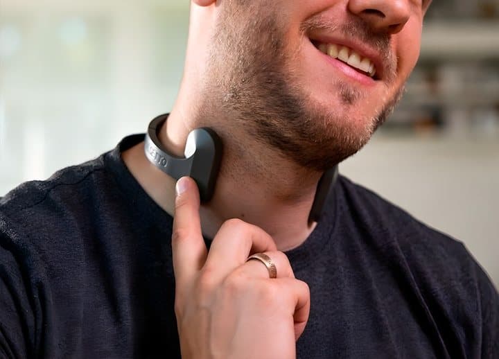 Man touching the side of his neck where the Pulsetto electrode rests