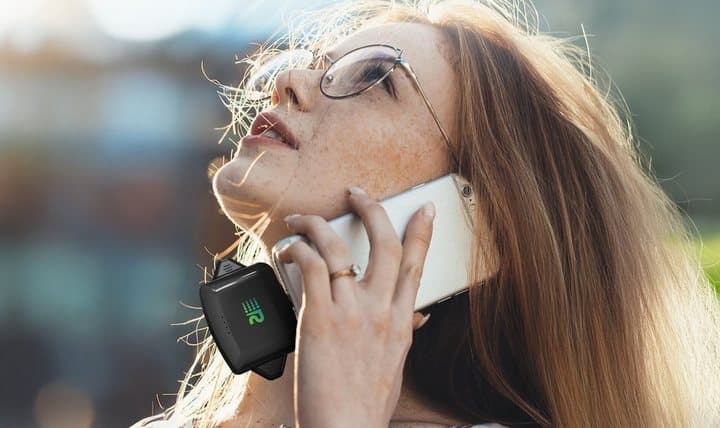 Woman on a phone call with a Rush Charge Universe attached to the bottom of her phone