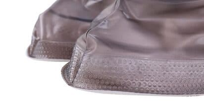 Close-up of the brown-tinted edge of ShoesCover Max with a dotted textured sole
