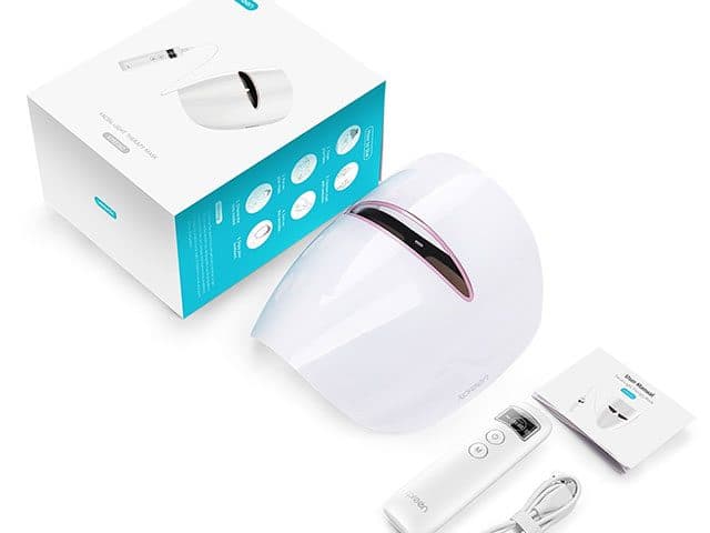 Boxed facial light therapy mask kit with the white mask, a handheld controller, a user manual and a USB cable