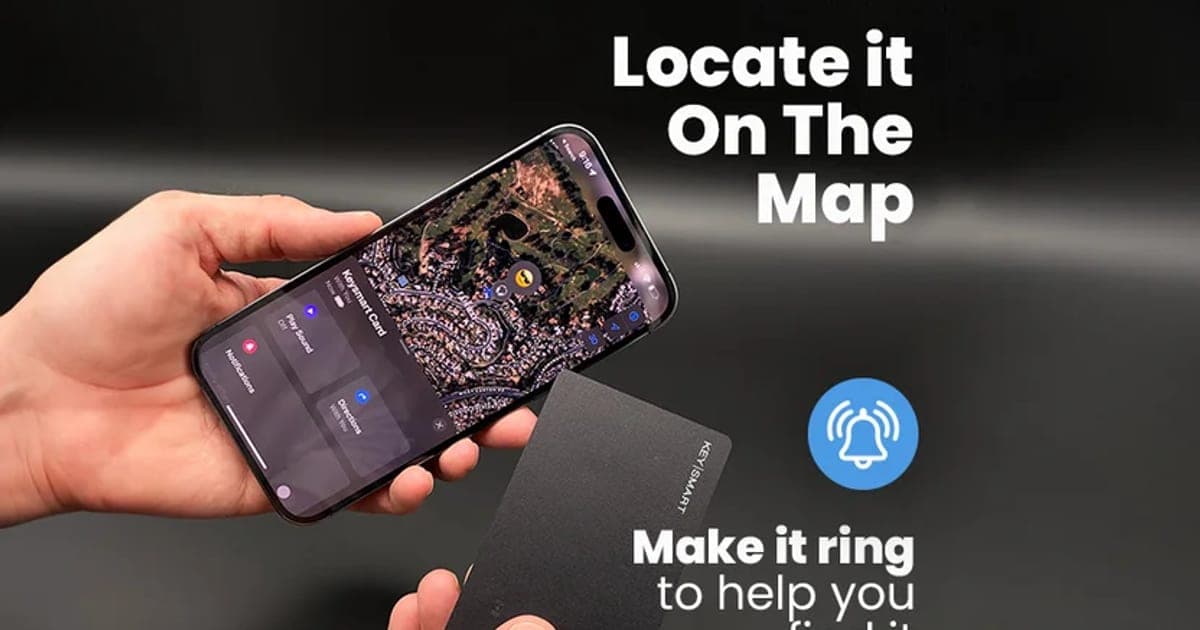 Hand holding a black KeySmart SmartCard beside a phone showing the Find My map with a ring-to-find button