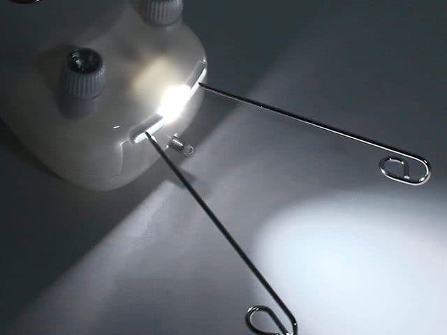 Close-up of the SoftEpilator Pro head with a small LED light shining between its two wire thread arms