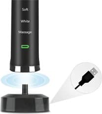 Black toothbrush handle labelled Soft, White and Massage on a black inductive charging base with a USB plug close-up