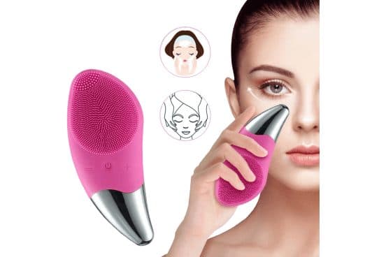 Pink SootheSkin Pro brush with silicone bristles, minus, power and plus buttons and a chrome tip, with a woman pressing the tip under her eye