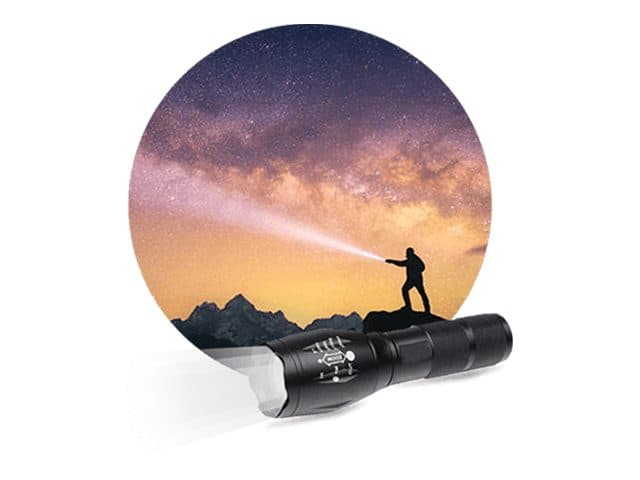Black zoomable tactical flashlight in front of a starry mountain scene with a hiker shining a beam