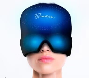 Woman wearing a TheraICE cap with a blue glow showing cold spreading around the head and eyes
