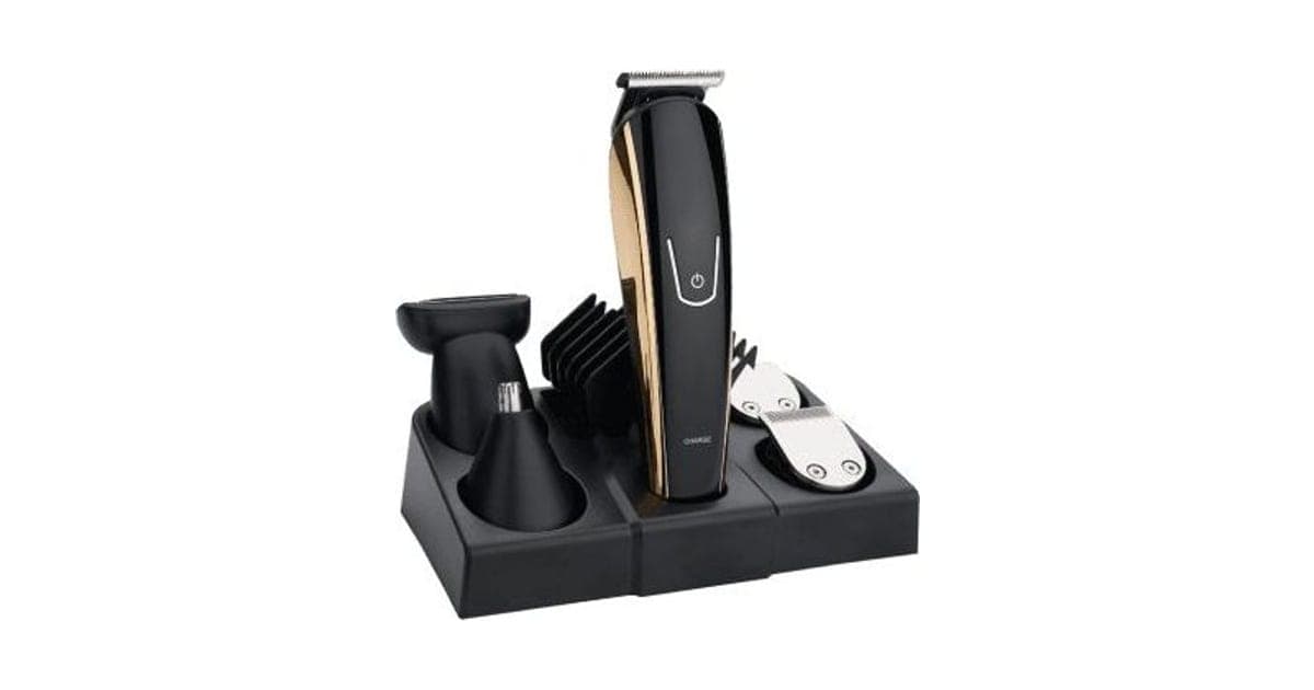 Black and gold TotalTrim Pro trimmer standing in a black charging stand with a shaver head, nose trimmer, guide combs and spare blades