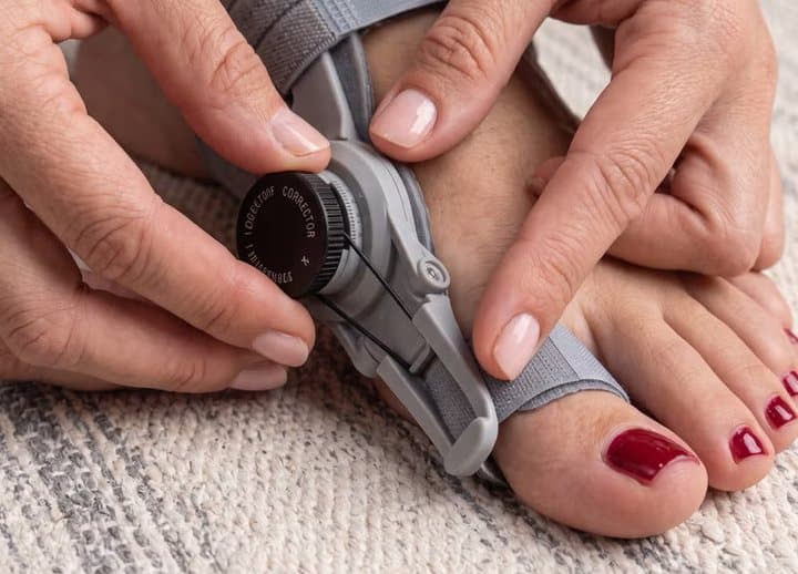 Hands turning the dial on the Treatmedy hinge while it is worn on a foot