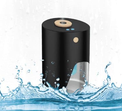 Black VapeSan Pro with a clear tank window, standing in a splash of water