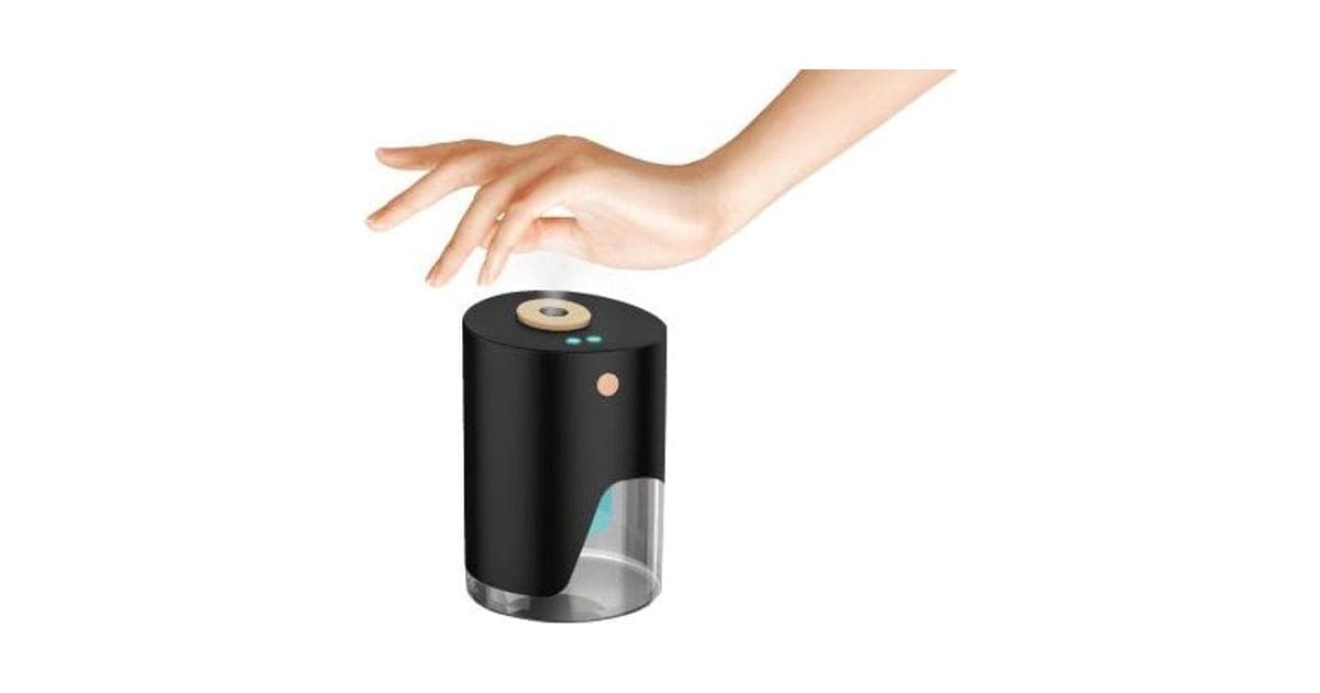 Black cylindrical VapeSan Pro dispenser with a wooden-look nozzle releasing mist under an outstretched hand