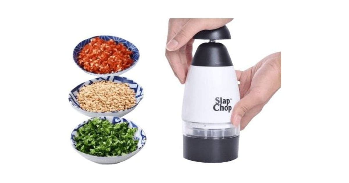 Hands pressing a white and black plunge chopper beside bowls of chopped chillies, nuts and herbs