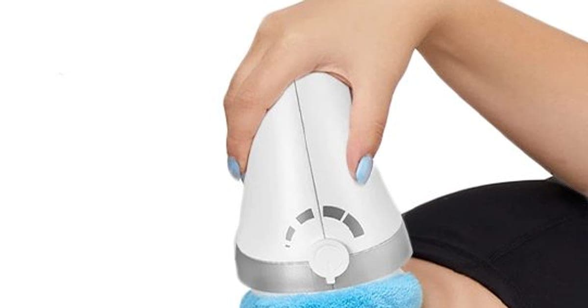 White VibraContour Pro massager with a blue cloth head held against a woman's thigh and hip